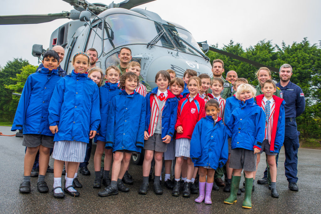 Truro Primary school children in front of helicopter during a visit from the Navy.