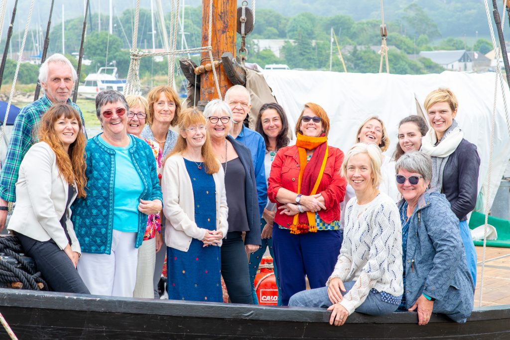 A group of School for Social Entrepreneurs course attendees in a Cornish harbour.