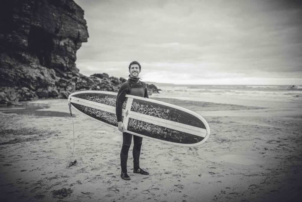 ActionCoach Truro's Tim Hill with his Cornish-themed surfboard